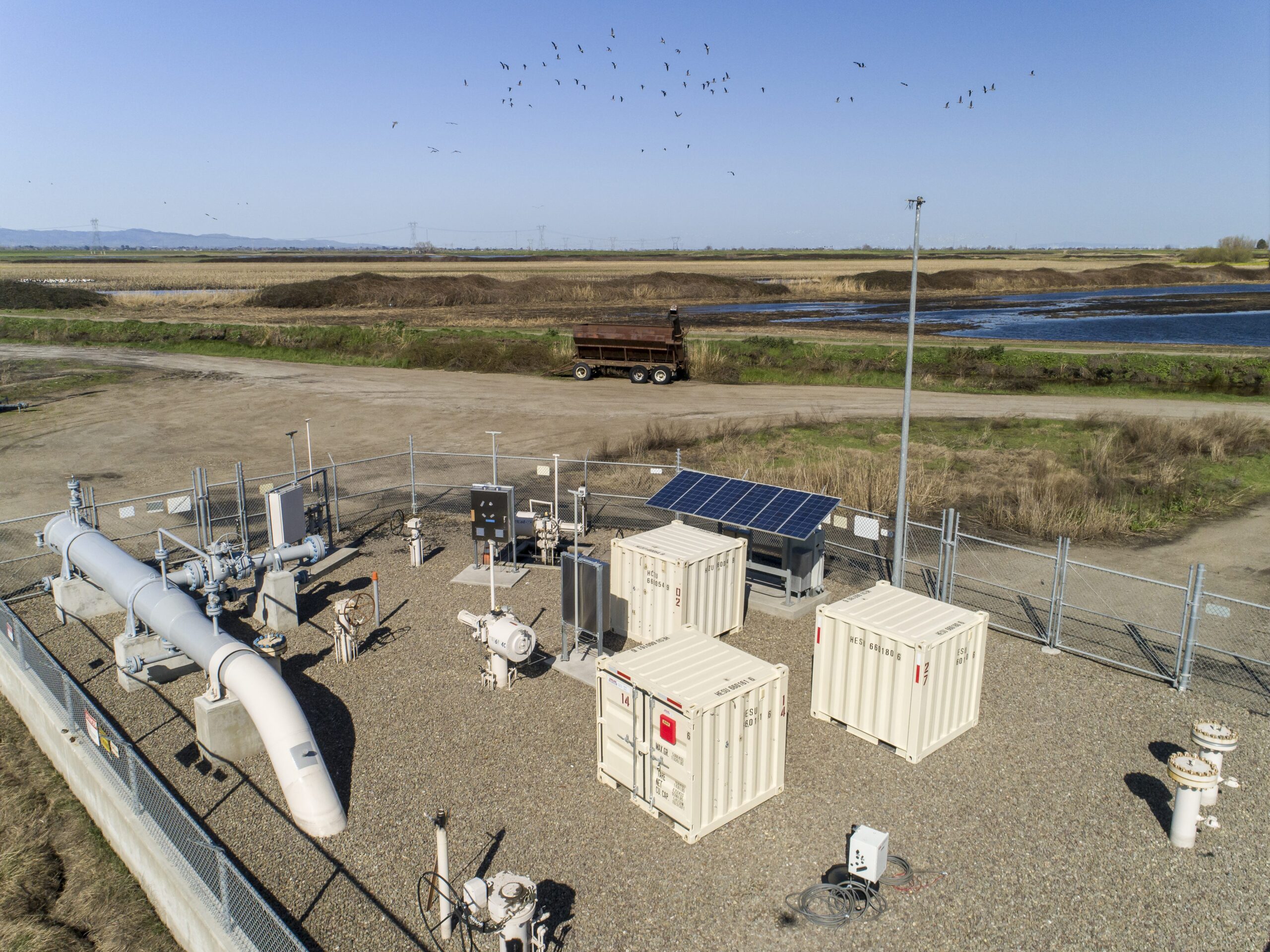 Natural gas odorization in wildlife sanctuary with a flock of birds flying in the background.